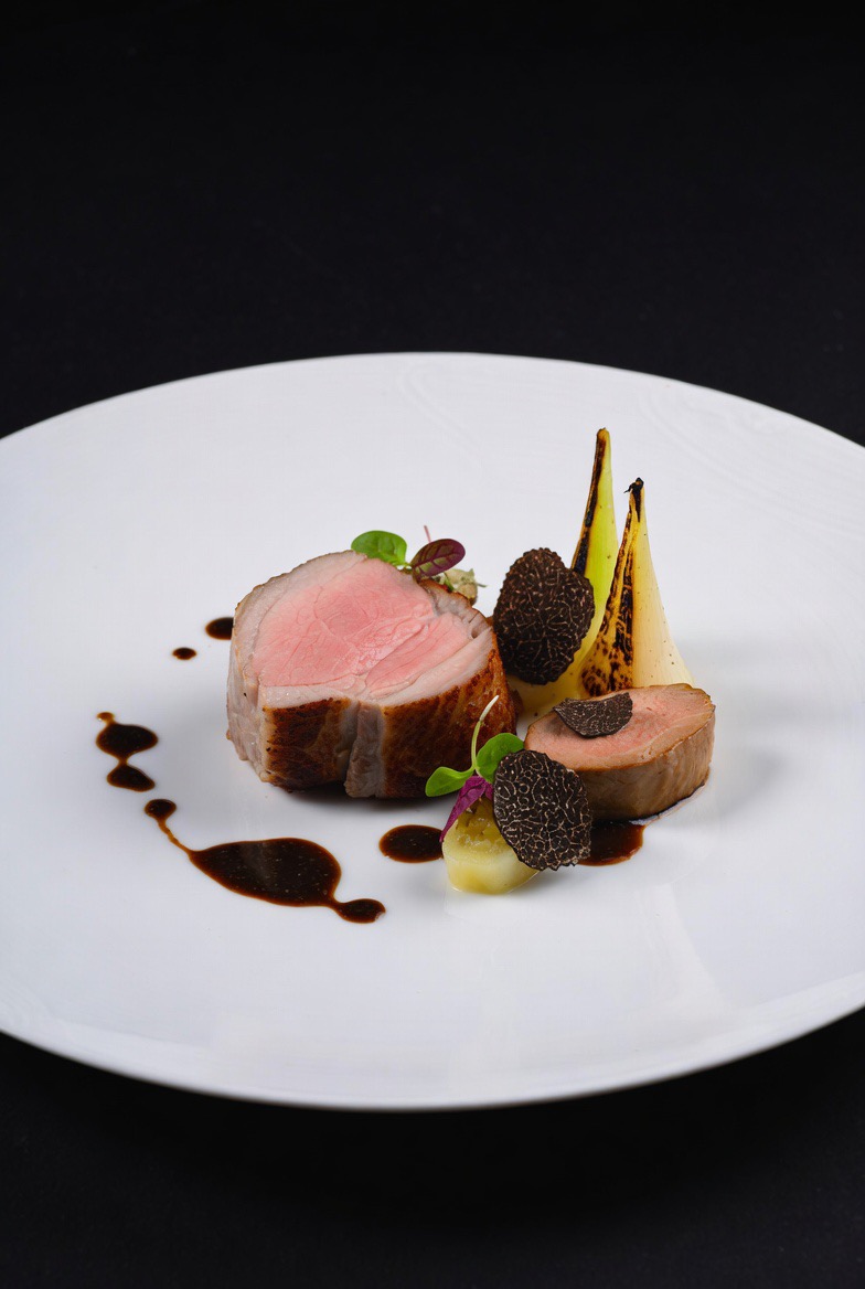 Sous-Vide Berkshire Pork Loin with Foie Gras Torchon, Black Truffle Jus & Charred Baby Leeks