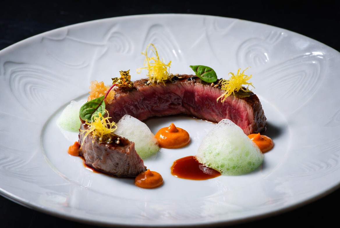 Yuzu-Glazed A5 Wagyu Tataki with Uni-Miso Purée, Gochujang Caramel, Thai Basil Espuma, and Crispy Rice Crumble